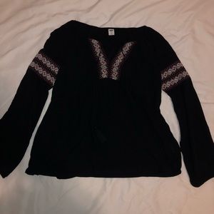 Black blouse with red and white detail